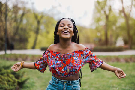 Beautiful young woman enjoying spring in the parkの写真素材