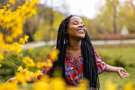 Beautiful young woman enjoying spring in the parkの写真素材