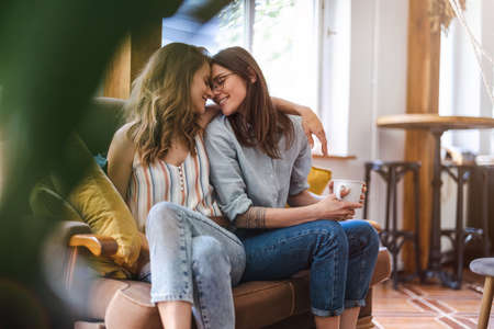 Portrait of affectionate lesbian couple embracing at home