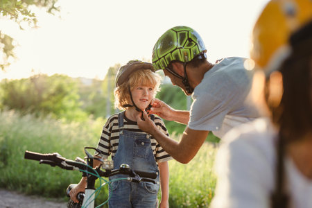 Shot of a father adjusting his son's helmetの写真素材