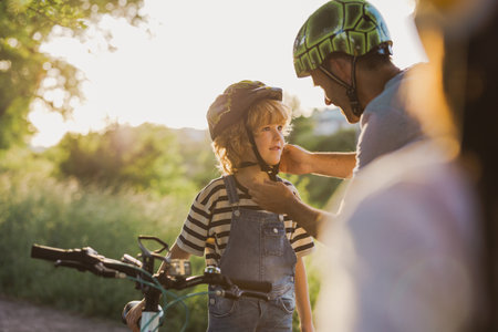 Shot of a father adjusting his son's helmetの写真素材