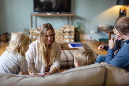 Happy young family having good time together at homeの写真素材