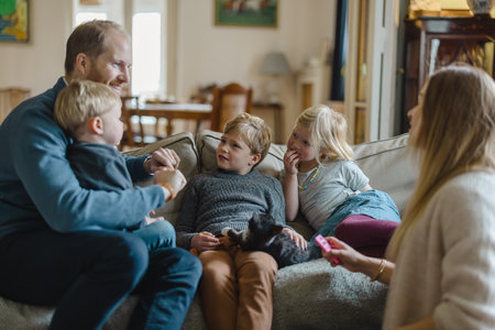 Happy young family having good time together at homeの写真素材