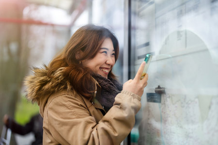 Beautiful young asian woman using mobile phone in the city.の写真素材