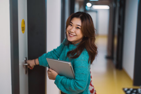 young asian woman standing in corridorの写真素材