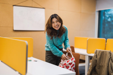 Smiling asian businesswoman at workplace in officeの写真素材