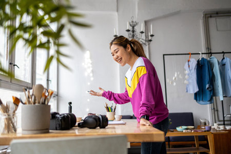 Portrait of a young female photographer standing in her studio and smilingの写真素材