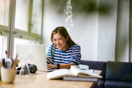 Young asian woman working on laptop computerの写真素材