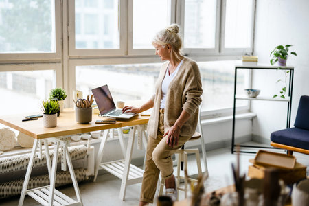 senior businesswoman using laptop at workplace in office, copy spaceの写真素材