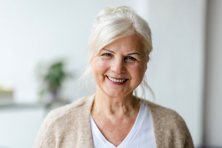 Portrait of smiling senior woman at home. Mature woman looking at the camera.の写真素材