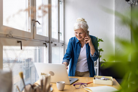 business, technology and people concept - happy senior businesswoman calling on smartphone at officeの写真素材