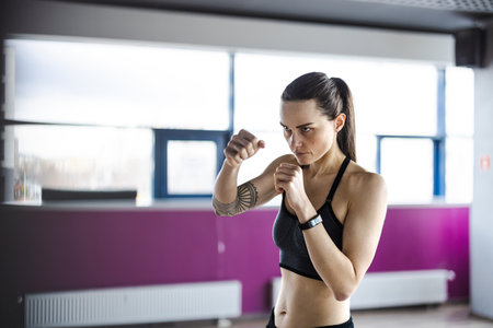 Portrait of a young woman boxing in a gym. fitness concept