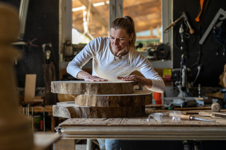 Craftsman working in his workshop, using a woodworking machineの写真素材