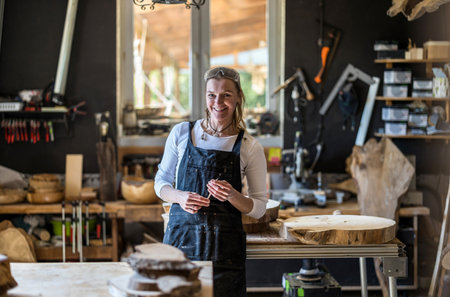 Portrait of a female potter standing in her workshop and smilingの写真素材
