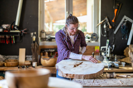 Carpenter working in his workshop on a piece of wood.の写真素材
