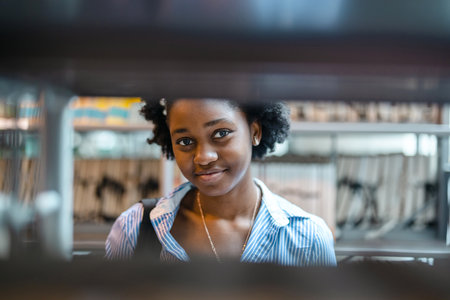 Portrait of smiling african american businesswoman standing in coffee shopの写真素材