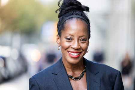 Closeup portrait of a happy african american woman smiling outdoorsの写真素材