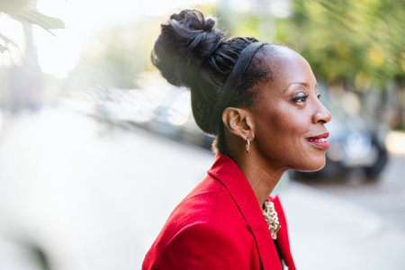 Portrait of a young African American business woman in red jacketの写真素材