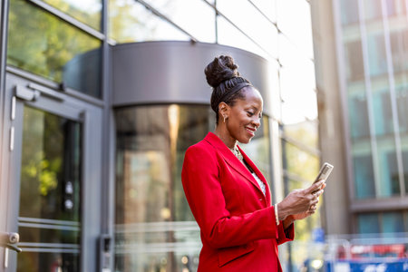 Businesswoman with smartphone in cityの写真素材