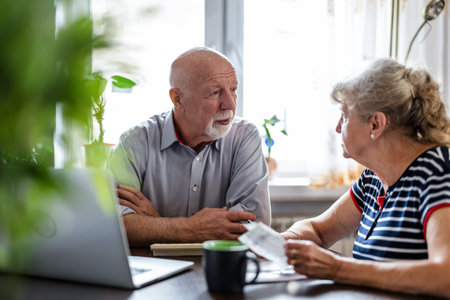 Senior couple using laptop at home. Senior man and woman sitting at the table.の写真素材