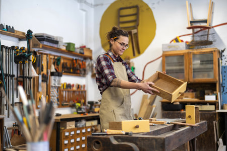Portrait of a female craftsman working in a workshopの写真素材