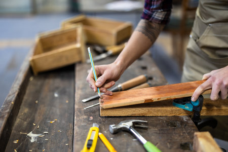 Carpenter working on her craft in a carpentry workshop.の写真素材