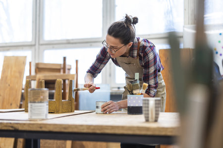portrait of a young caucasian female carpenter at workの写真素材