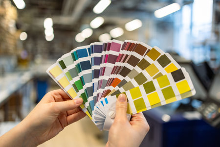 interior design and renovation concept - close up of woman choosing color from color swatch samplesの写真素材