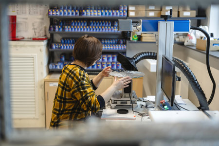 Young female technician working on a 3d printer in a factory.の写真素材