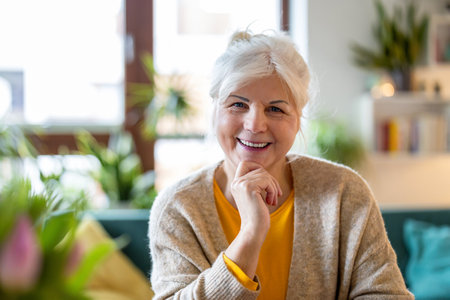 Portrait of smiling senior woman at home. Mature woman looking at camera and smiling.