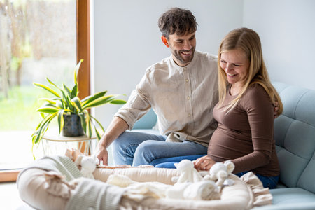 Young pregnant woman with her husband at home. Happy pregnant woman and her husband at home. Maternity prenatal care and woman pregnancy concept.の写真素材