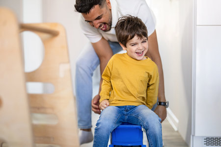 Father and son playing in the room at home. Concept of friendly family.の写真素材