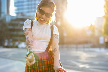 Portrait of a beautiful young woman with tattoos on her armsの写真素材
