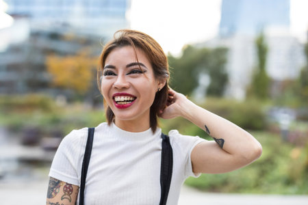 Portrait of a beautiful young Asian woman smiling in the cityの写真素材
