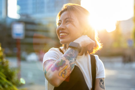 Portrait of smiling tattooed woman in the cityの写真素材