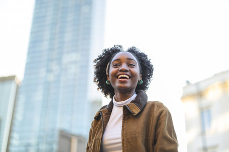 Portrait of a beautiful young african american woman smiling outdoorsの写真素材