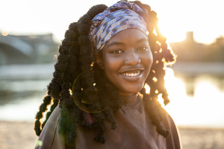 Portrait of a beautiful young African woman smiling at the camera.の写真素材