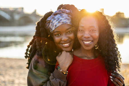 Portrait of two African American women smiling on the beachの写真素材