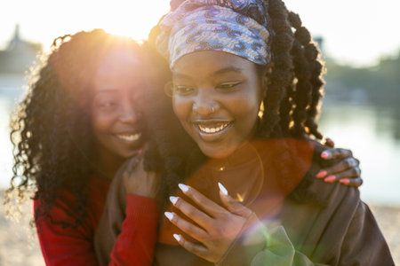Portrait of two afro american women smiling at camera outdoorsの写真素材