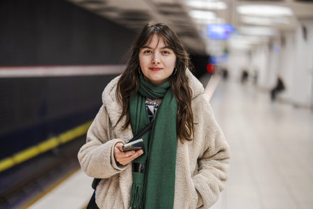 Portrait of a young woman in a subway station waiting for a trainの写真素材