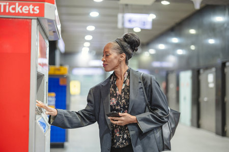 Woman using a mobile phone in the subway stationの写真素材