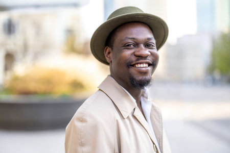 Portrait of happy african american man in hat smiling outdoorsの写真素材