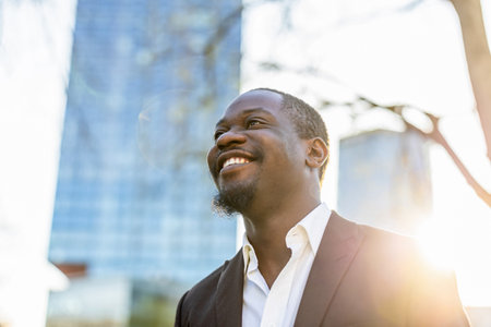 Close up portrait of a happy african american businessman smiling outdoorsの写真素材