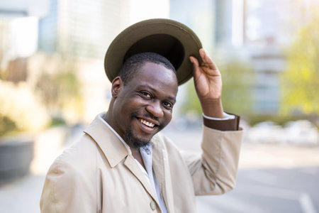 Portrait of a smiling african american man in hat outdoorsの写真素材