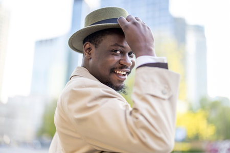 Handsome african american man in a hat in the cityの写真素材