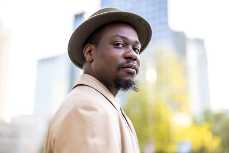 Portrait of a handsome African American man in hat outdoors
