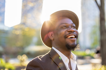 Portrait of smiling african american man in hat in parkの写真素材