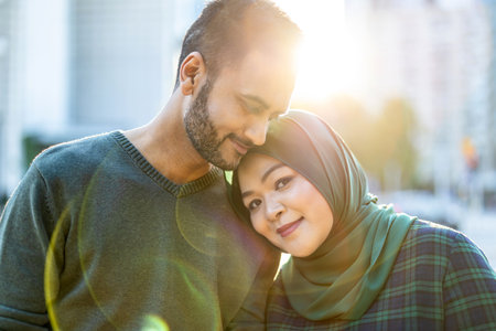 Portrait of muslim couple looking at each other while standing outdoorsの写真素材