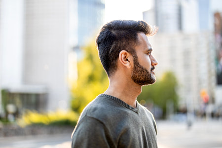 Portrait of a handsome young man with a bear in the city streetsの写真素材