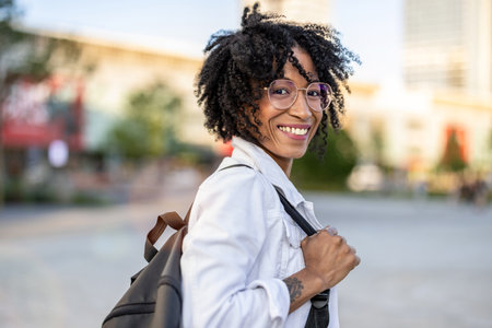 young beautiful afro american woman in the city with a backpack